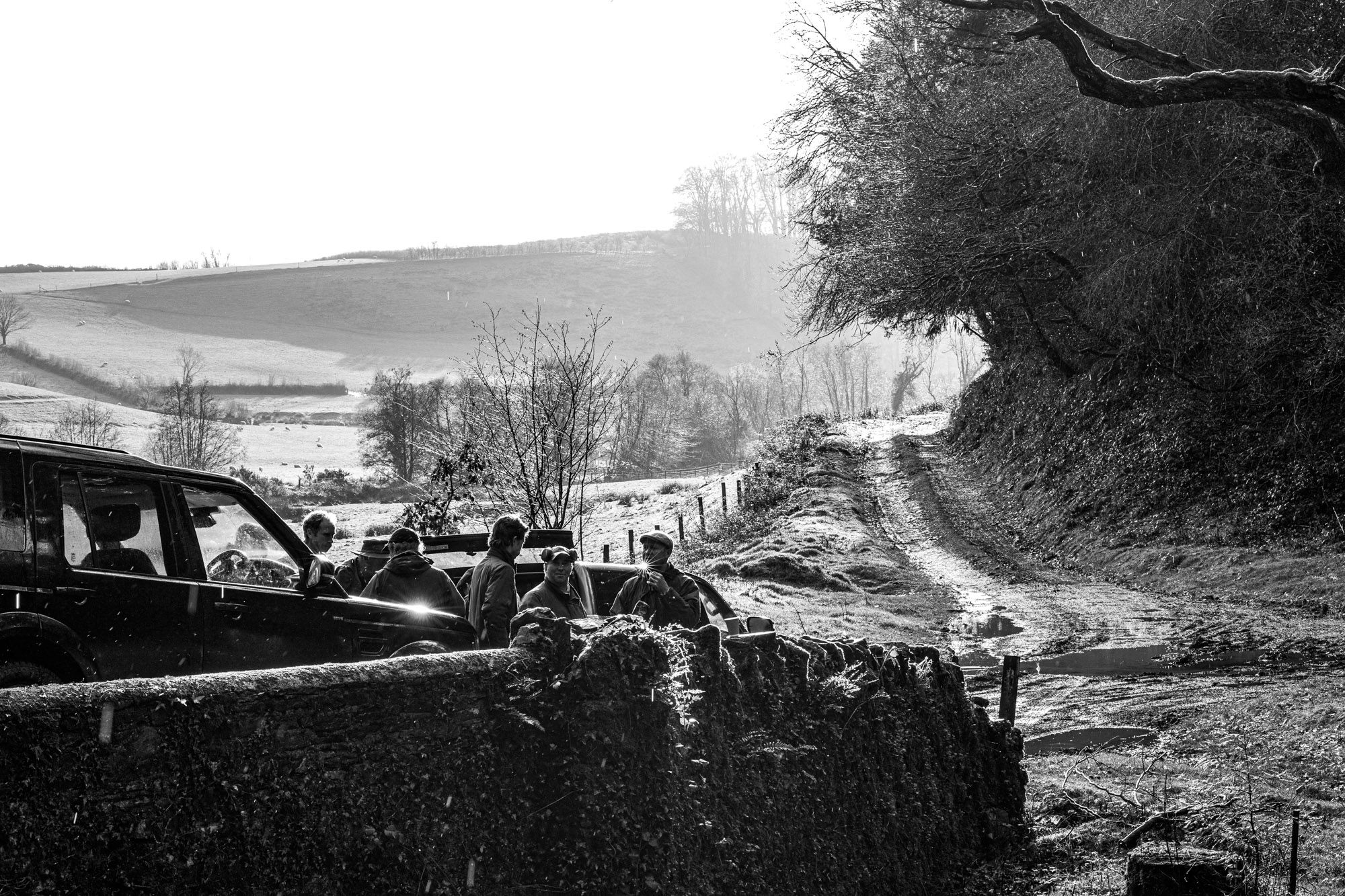 A group of shooters talking by their vehicles before they set off for a morning shoot.